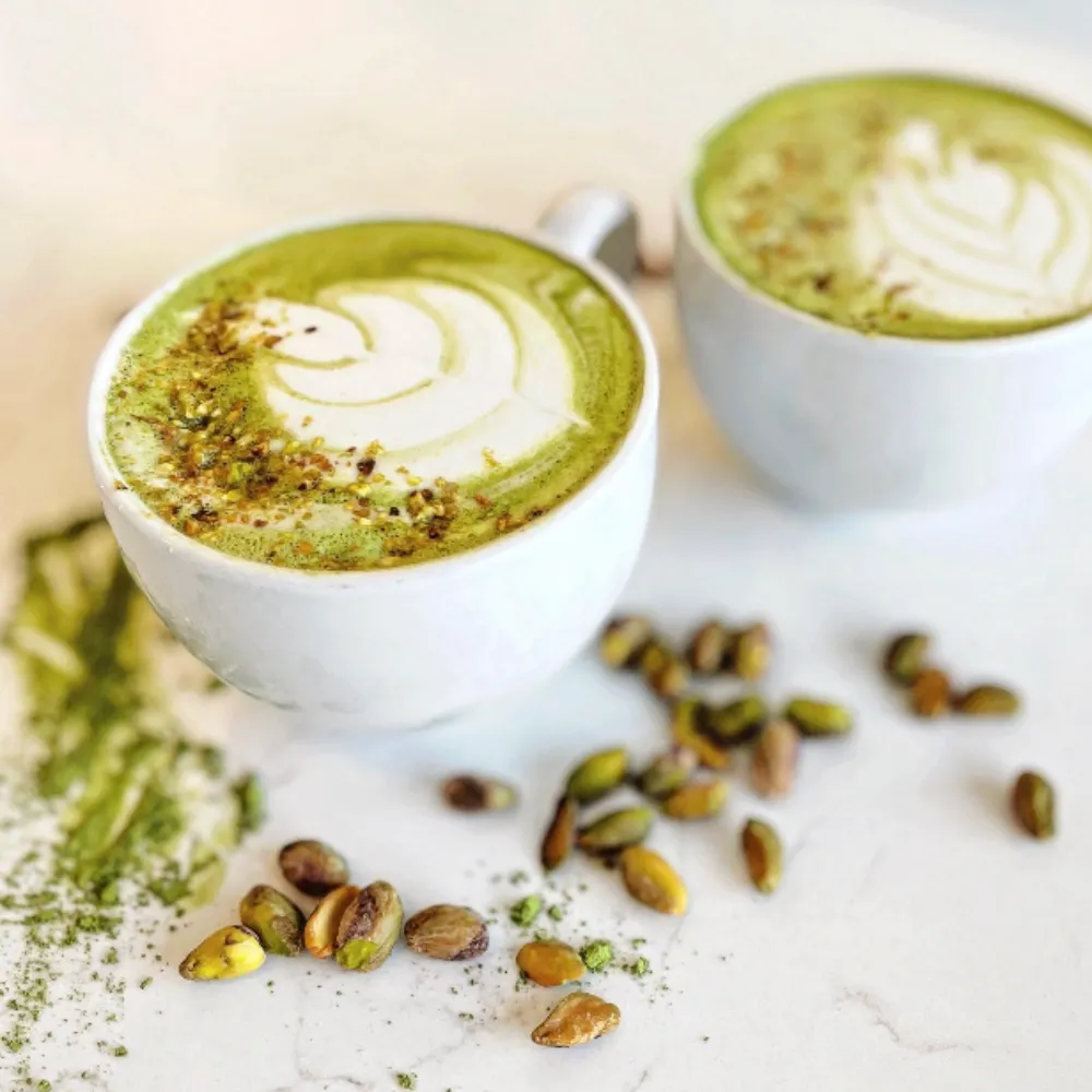 2 cups of artisan, Matcha, green tea latte with pistachio beans.